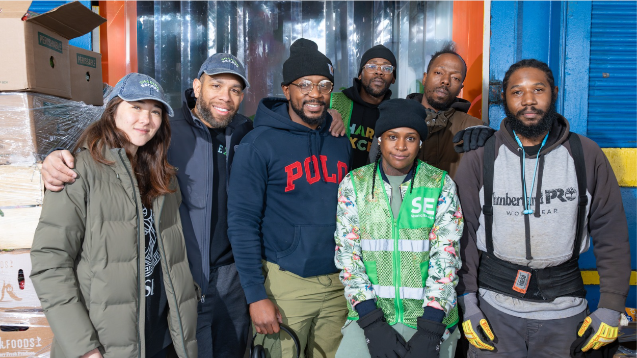 Sharing Excess team standing together at a hub warehouse